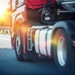 Truck driving down road