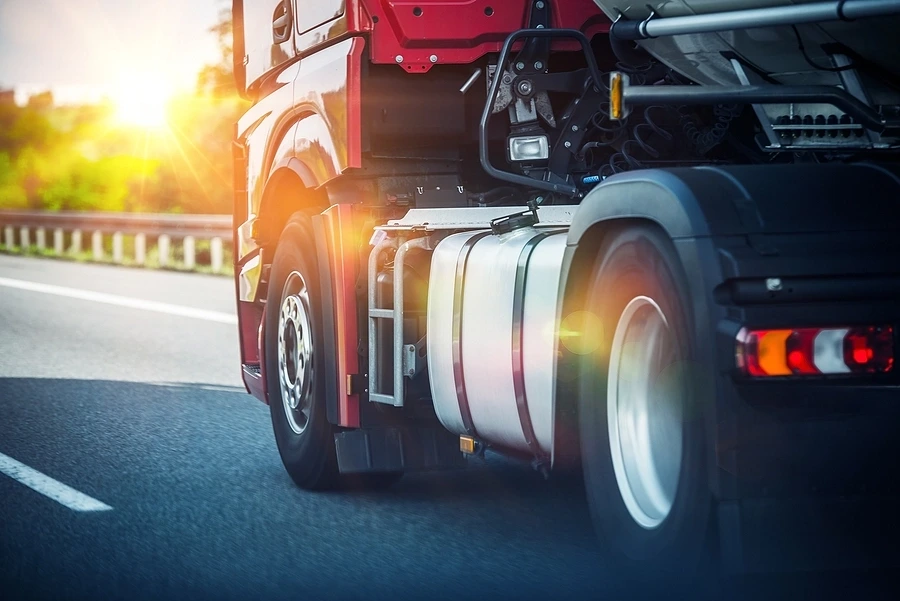 Truck driving down road